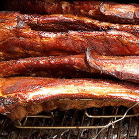 Pork ribs standing sideways in a rack